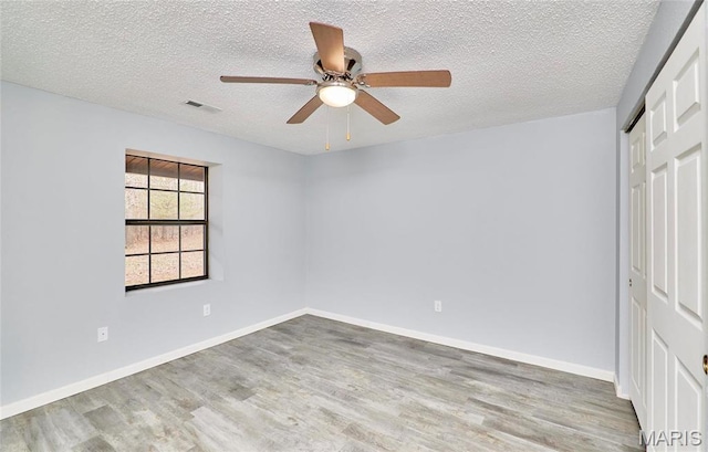 10994 Webster Rd, Caledonia, MO 63631 - unfurnished bedroom featuring wood finished floors, a closet, a textured ceiling, and a ceiling fan