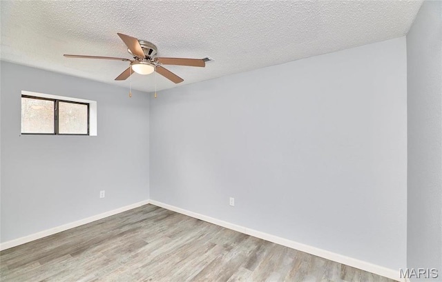 10994 Webster Rd, Caledonia, MO 63631 - empty room featuring wood finished floors, ceiling fan, and a textured ceiling