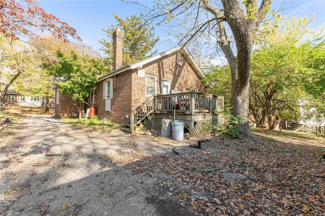 7510 Springdale Dr, Saint Louis, MO 63121 - view of home's exterior featuring brick siding, a chimney, and a deck