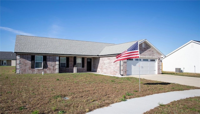 ranch-style home with driveway, a garage, a front lawn, and brick siding