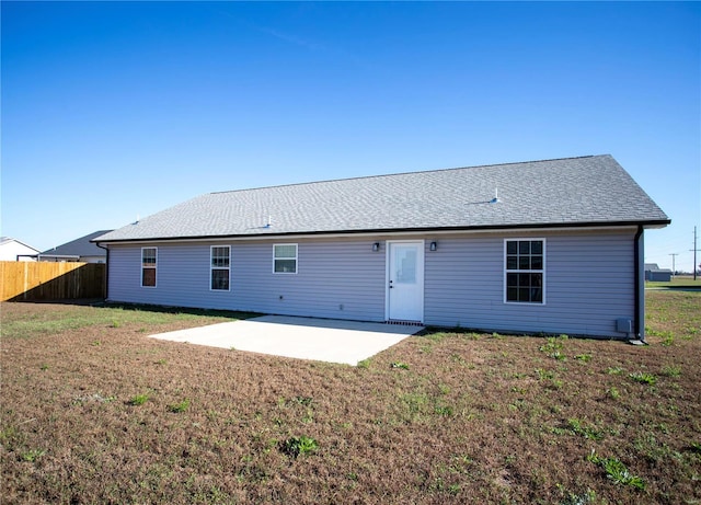 back of house with a patio and a shingled roof