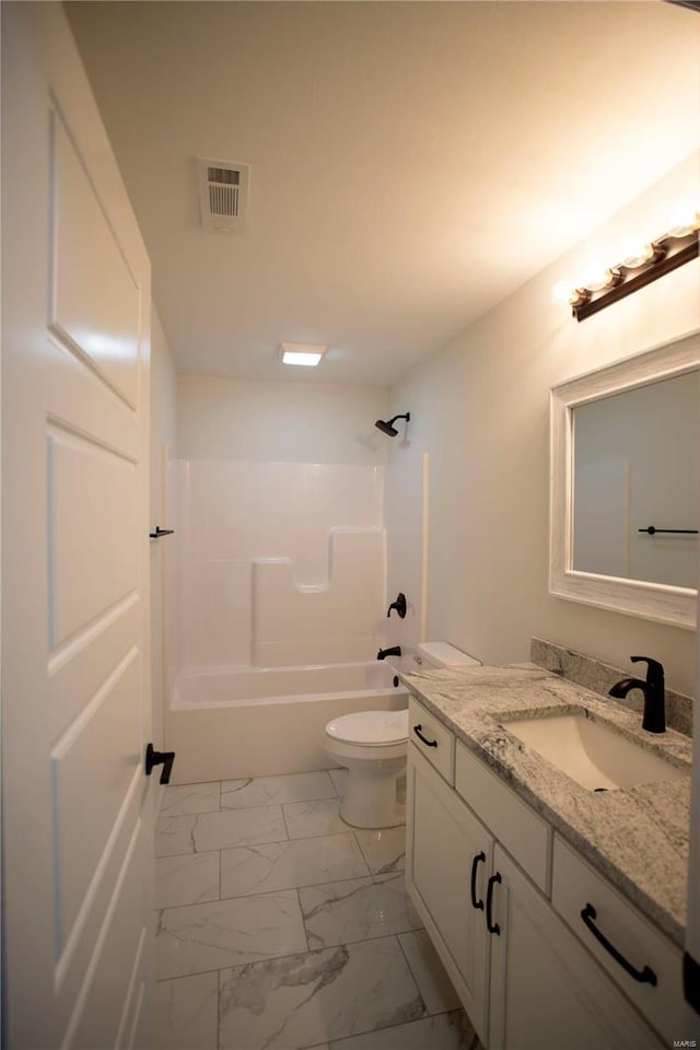 full bathroom featuring marble look tile flooring, washtub / shower combination, vanity, and toilet