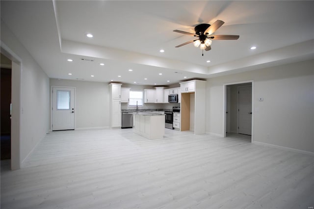 kitchen with stainless steel appliances, open floor plan, light wood finished floors, recessed lighting, and ceiling fan