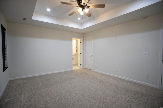 unfurnished room with a raised ceiling, a ceiling fan, baseboards, light carpet, and recessed lighting