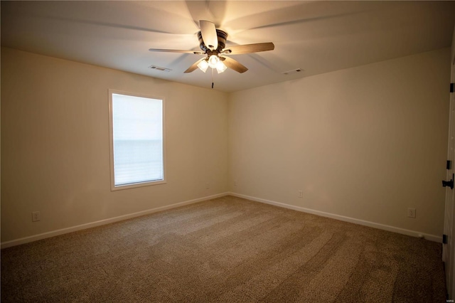 empty room featuring carpet flooring, a ceiling fan, and baseboards