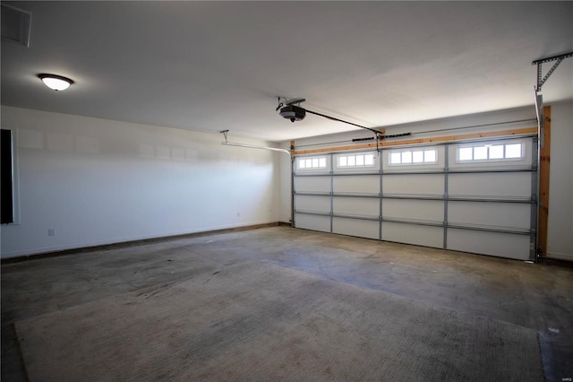 garage featuring a garage door opener and baseboards