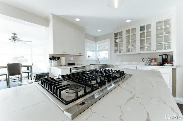 10605 Larson Ln, Rolla, MO 65401 - kitchen featuring a sink, white cabinets, glass insert cabinets, light stone countertops, and recessed lighting