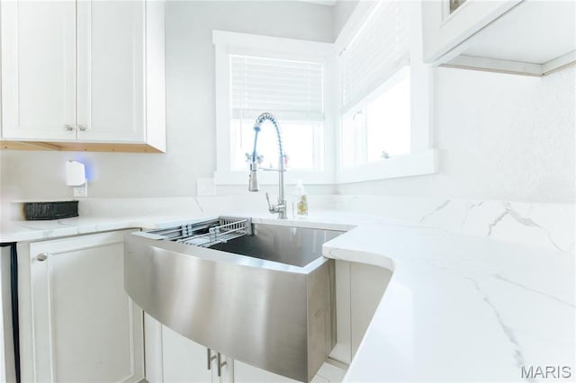 10605 Larson Ln, Rolla, MO 65401 - kitchen featuring a sink, light stone counters, and white cabinetry