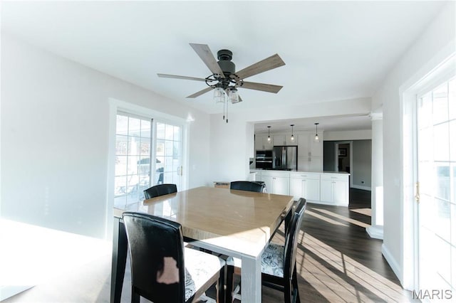 10605 Larson Ln, Rolla, MO 65401 - dining area featuring a ceiling fan, dark wood-style floors, and baseboards