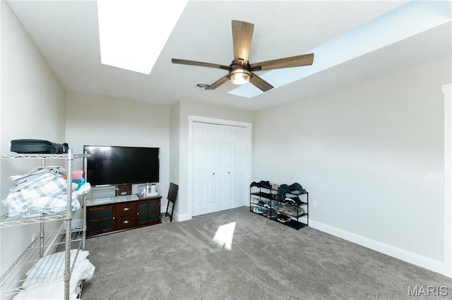 10605 Larson Ln, Rolla, MO 65401 - bedroom featuring carpet flooring, baseboards, a closet, ceiling fan, and a skylight