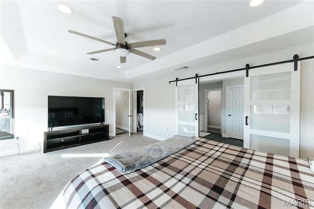 10605 Larson Ln, Rolla, MO 65401 - carpeted bedroom with a barn door, a raised ceiling, recessed lighting, baseboards, and a ceiling fan