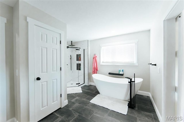 10605 Larson Ln, Rolla, MO 65401 - full bathroom with a shower stall, a freestanding tub, stone finish floors, and baseboards