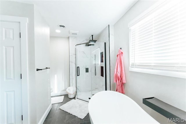 10605 Larson Ln, Rolla, MO 65401 - bathroom with a marble finish shower, a freestanding bath, and baseboards