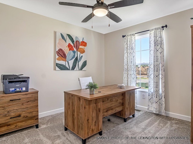 carpeted home office featuring baseboards and ceiling fan