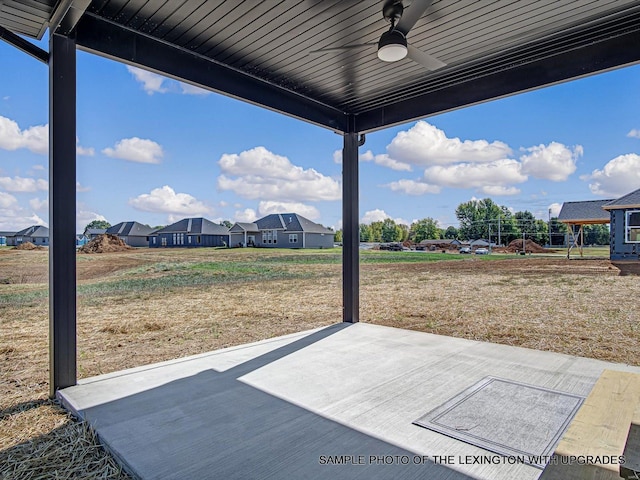 view of patio featuring ceiling fan and a residential view
