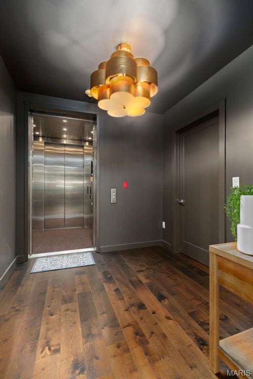 4545 Lindell Blvd Unit 3, Saint Louis, MO 63108 - spare room featuring elevator, dark wood finished floors, a chandelier, and baseboards