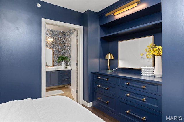 4545 Lindell Blvd Unit 3, Saint Louis, MO 63108 - bedroom with a sink, dark wood-style floors, ensuite bathroom, and baseboards