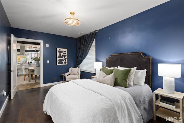 4545 Lindell Blvd Unit 3, Saint Louis, MO 63108 - bedroom with a chandelier, wood finished floors, and baseboards
