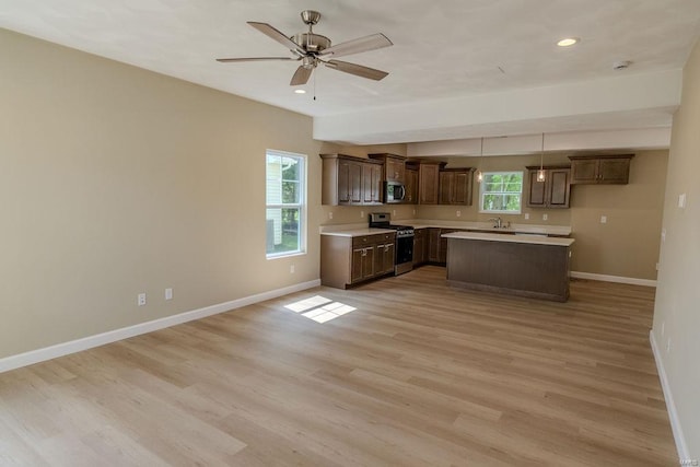 1461 Lexi Ln, Mascoutah, IL 62258 - kitchen with appliances with stainless steel finishes, light countertops, baseboards, light wood-style floors, and recessed lighting