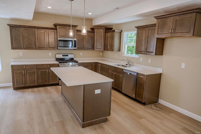 1461 Lexi Ln, Mascoutah, IL 62258 - kitchen featuring appliances with stainless steel finishes, a sink, baseboards, light wood-type flooring, and recessed lighting
