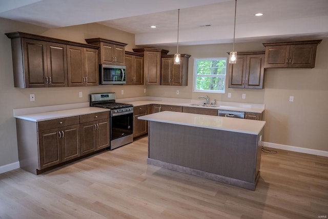 1461 Lexi Ln, Mascoutah, IL 62258 - kitchen featuring appliances with stainless steel finishes, a sink, light wood-type flooring, and recessed lighting
