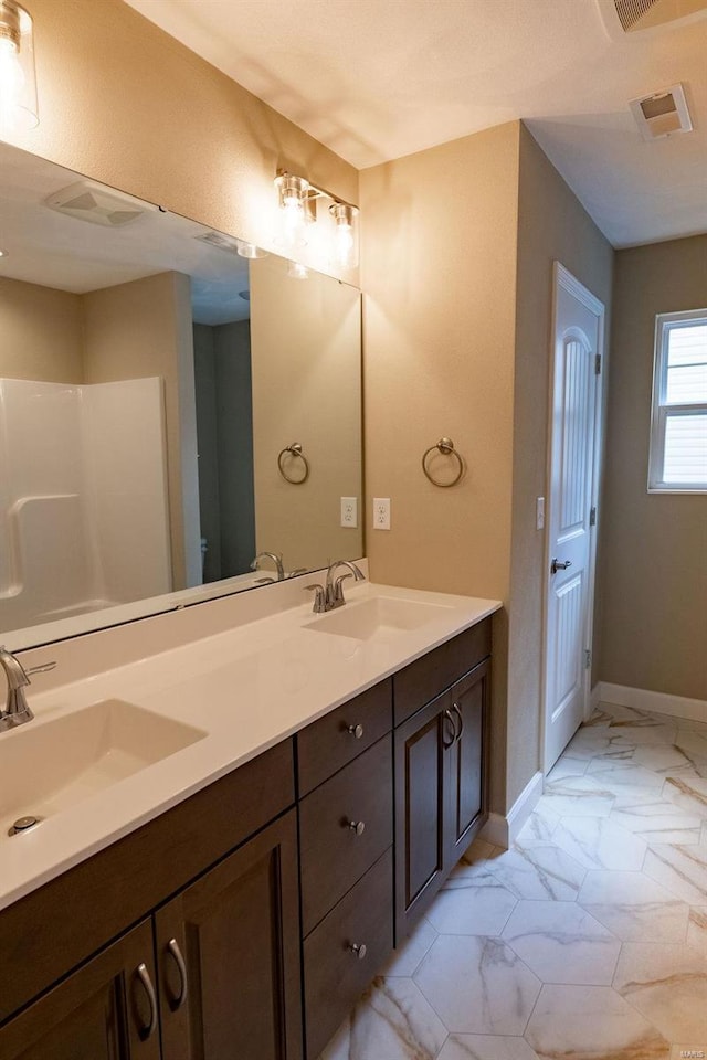 1461 Lexi Ln, Mascoutah, IL 62258 - full bathroom with marble look tiles, baseboards, double vanity, and a shower