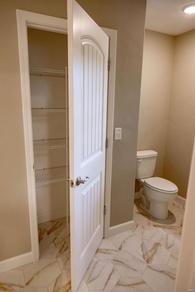 1461 Lexi Ln, Mascoutah, IL 62258 - bathroom featuring marble finish flooring, toilet, baseboards, and a walk in closet