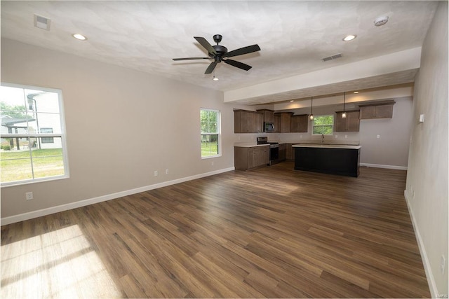 1453 Lexi Ln, Mascoutah, IL 62258 - unfurnished living room featuring baseboards, dark wood-type flooring, a ceiling fan, recessed lighting, and a sink