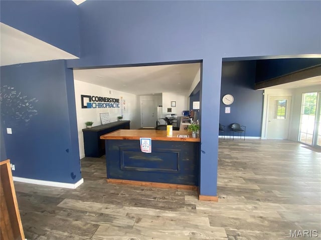 1 Proactive Dr, New Florence, MO 63363 - kitchen with wood counters, wood finished floors, baseboards, blue cabinets, and a high ceiling