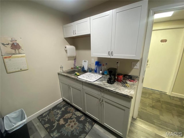 1 Proactive Dr, New Florence, MO 63363 - kitchen with baseboards, a sink, and white cabinets