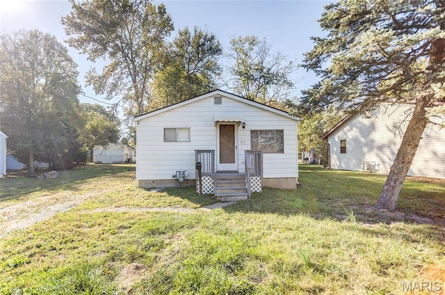 bungalow-style home featuring a front yard