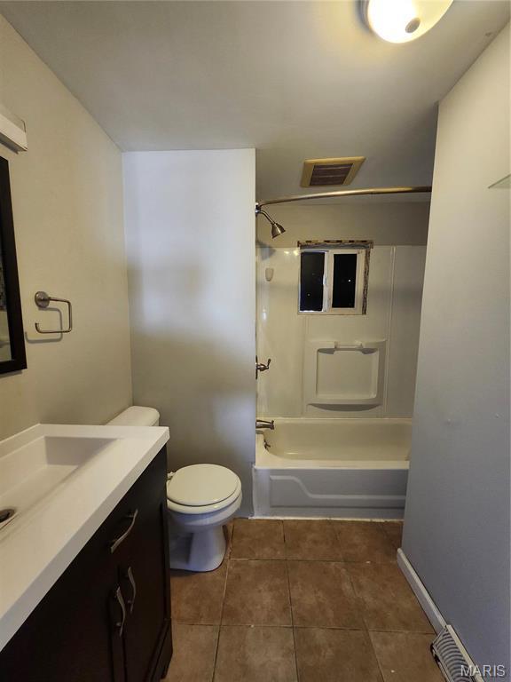 full bath with vanity, tile patterned floors, toilet, and shower / washtub combination