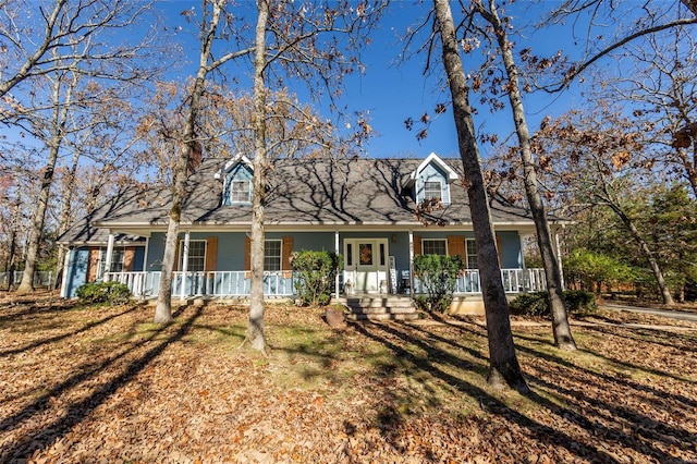 new england style home with covered porch