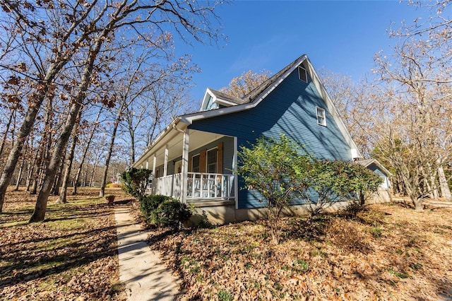 view of property exterior featuring covered porch