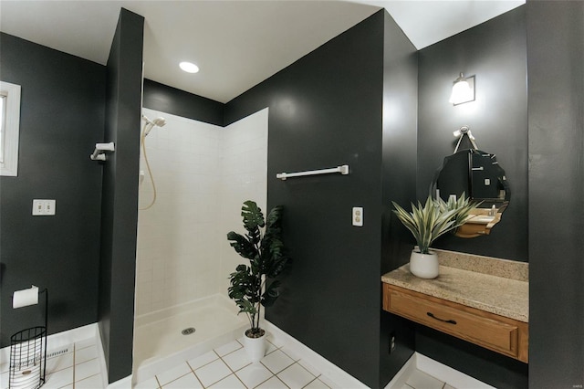 full bathroom featuring tiled shower, tile patterned floors, and baseboards