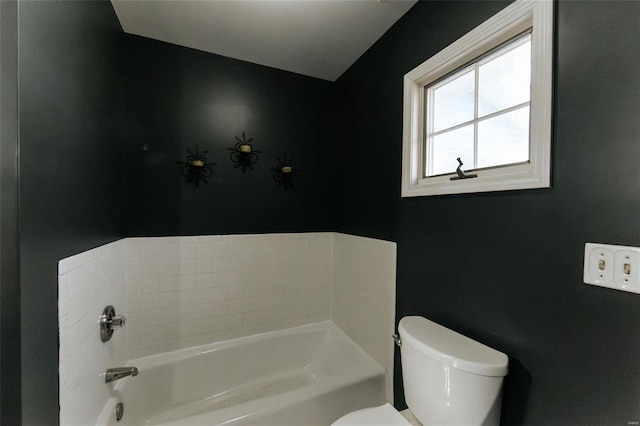 bathroom featuring toilet and a garden tub