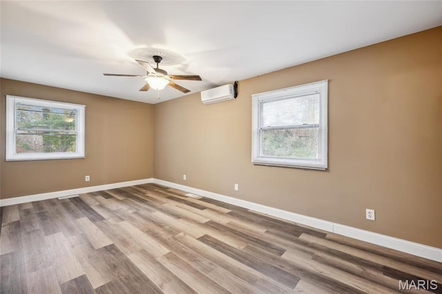 15 Chamblee Ln, Saint Louis, MO 63141 - unfurnished room with a wall mounted air conditioner, a ceiling fan, baseboards, and wood finished floors