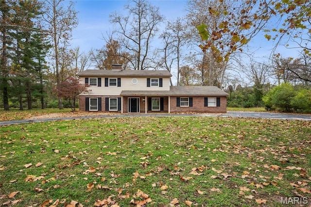15 Chamblee Ln, Saint Louis, MO 63141 - view of front facade featuring brick siding, a front lawn, and covered porch