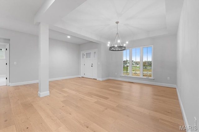 unfurnished dining area featuring a chandelier, light wood-style floors, baseboards, and recessed lighting