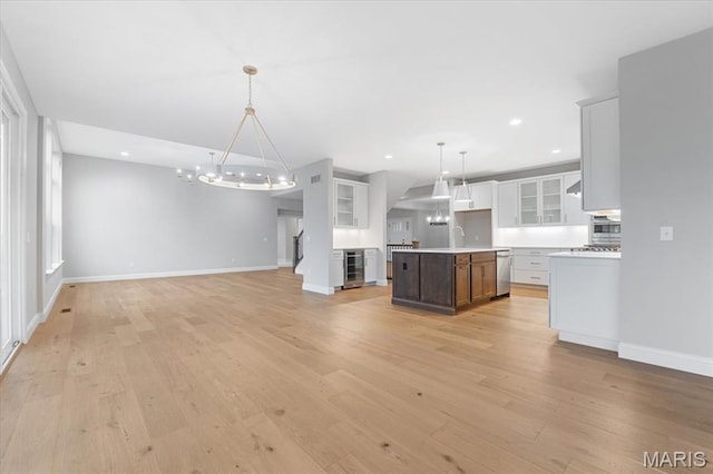 kitchen featuring open floor plan, wine cooler, a chandelier, dishwasher, and recessed lighting