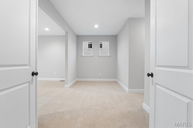 unfurnished room featuring light carpet, baseboards, and recessed lighting