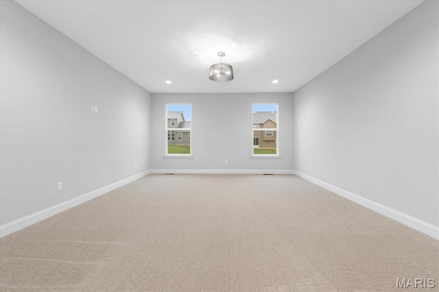 unfurnished room featuring baseboards, light carpet, and recessed lighting