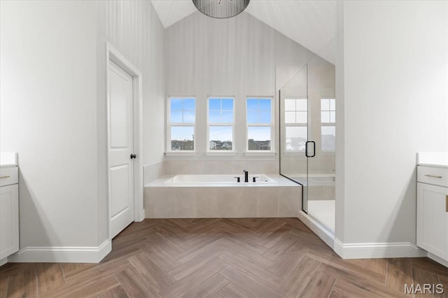 full bath featuring vanity, baseboards, a stall shower, a garden tub, and high vaulted ceiling