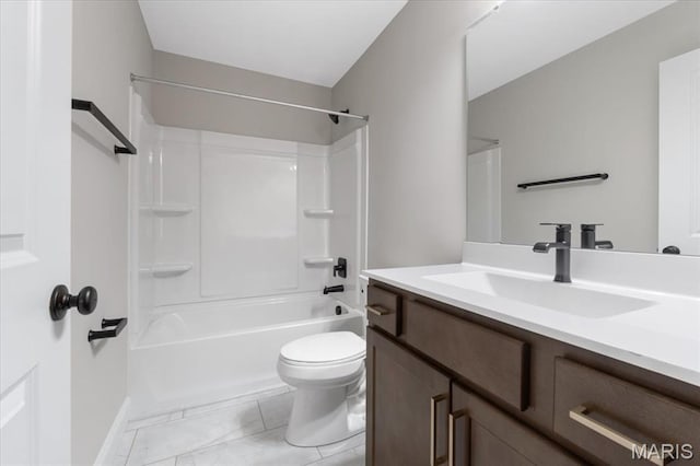 bathroom featuring toilet, vanity, baseboards, and shower / tub combination