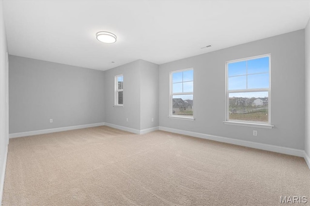 empty room with baseboards and light carpet