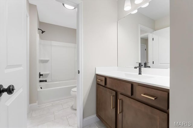 full bath with vanity, baseboards, toilet, shower / bathtub combination, and marble look tiles