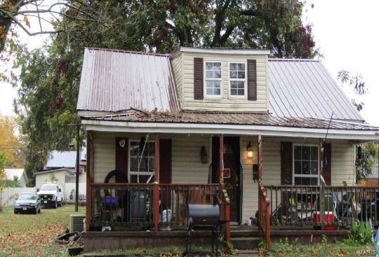 view of front of property with a porch and metal roof