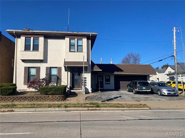 125 S 5th, Saint Charles, MO 63301 - view of front facade featuring a garage, driveway, and stucco siding