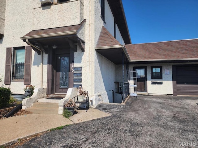 125 S 5th, Saint Charles, MO 63301 - view of exterior entry featuring stucco siding and roof with shingles