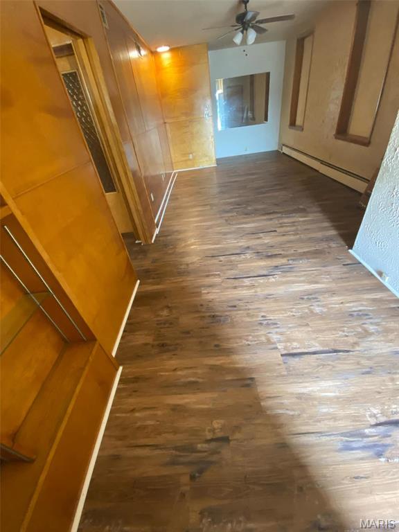 125 S 5th, Saint Charles, MO 63301 - hallway featuring wood finished floors and a baseboard radiator